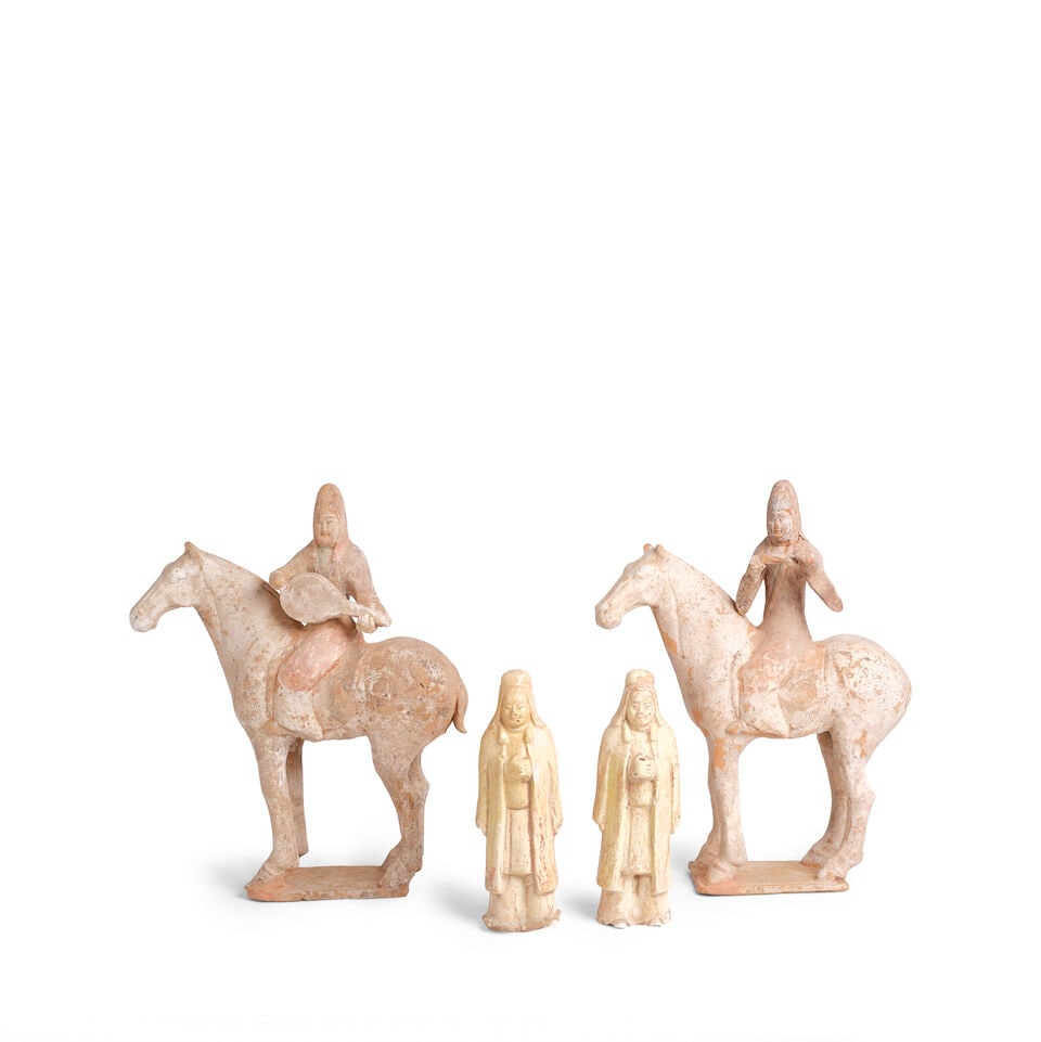 A GROUP OF FOUR POTTERY FIGURES Tang dynasty: A GROUP OF FOUR POTTERY FIGURES Tang dynasty Comprising two musician horses and riders, and two standing attendant figures. Musicians: each 13in (33cm) height of taller; figures: each 7 1/8in (18cm) h