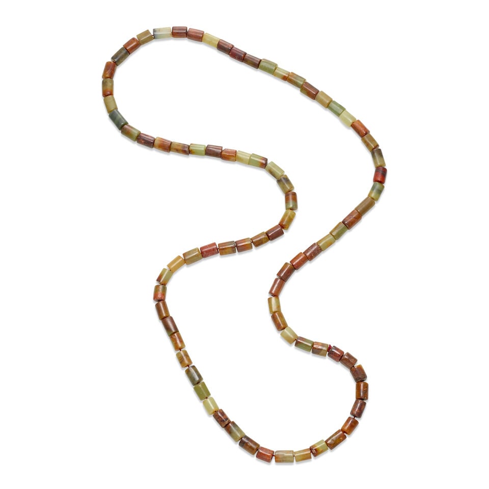 A LONG STRAND OF JADE AND HARDSTONE BEADS Late Qing dynasty, probably including earlier elements: A LONG STRAND OF JADE AND HARDSTONE BEADS Late Qing dynasty, probably including earlier elements The bead featuring eighty-two small tubular jade carvings. 22in (56cm) long Footnotes: 晚清