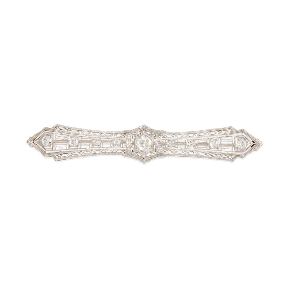 ART DECO PLATINUM, 14K GOLD AND DIAMOND BAR BROOCH: ART DECO PLATINUM, 14K GOLD AND DIAMOND BAR BROOCH • Platinum and 14K white gold • Numerous round shaped diamonds weighing approximately 1.10-1.20 carats total • Dimensions: 3 in x 1