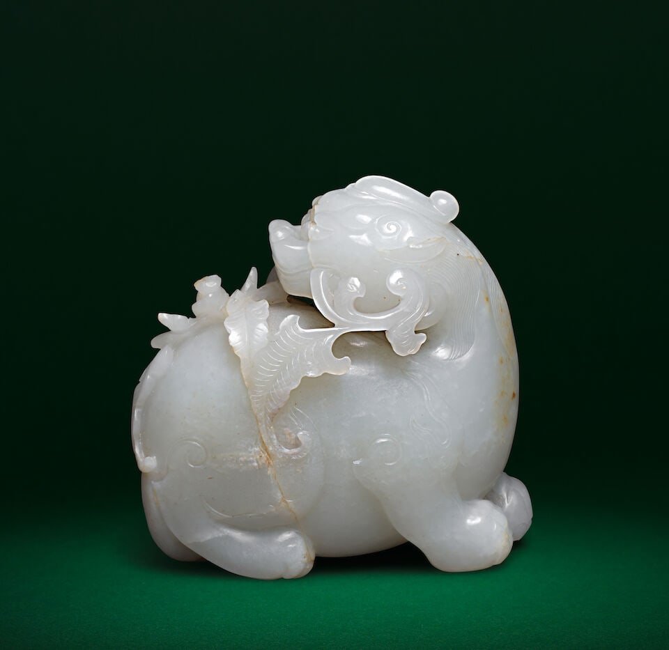 A WHITE-GREY AND RUSSET JADE CARVING OF A QILIN 18th century - 2