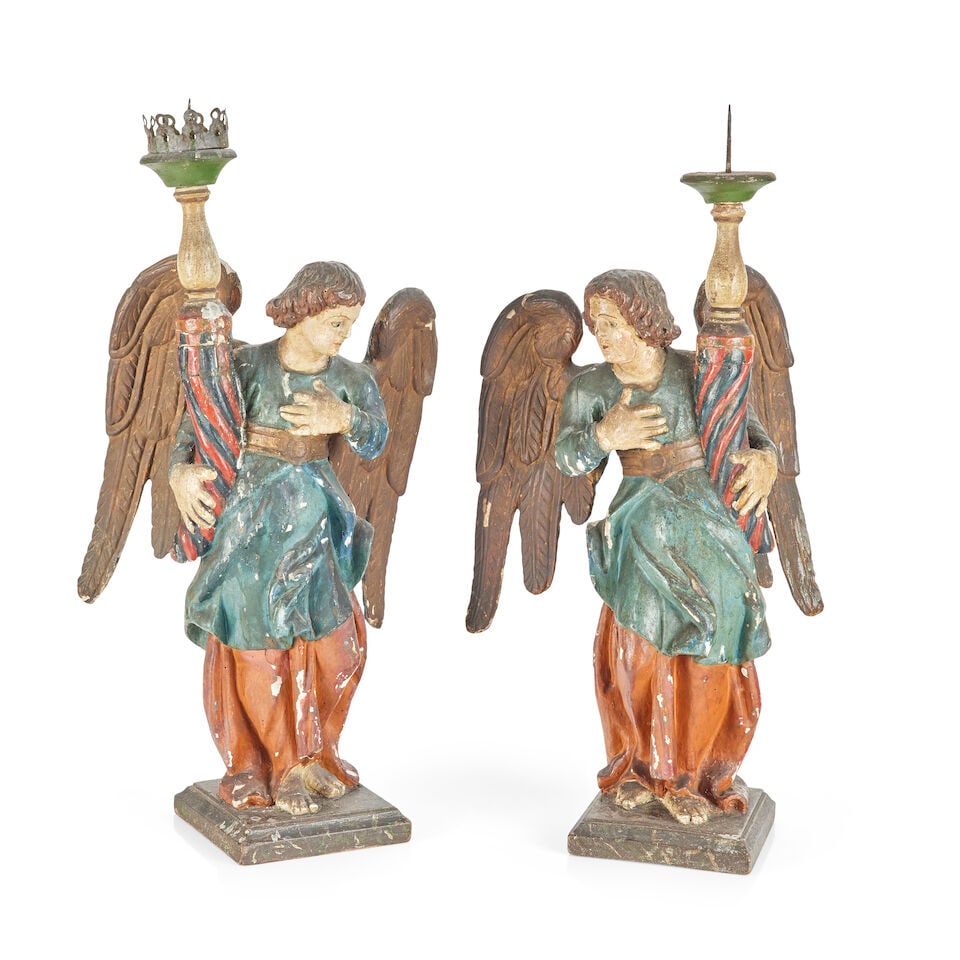A pair of polychrome gesso and carved wooden angel lamps, probably 19th century (2): A pair of polychrome gesso and carved wooden angel lamps, probably 19th century Each carved standing holding a spirally carved candle support and sconce, the rear with iron attachment point, raised on