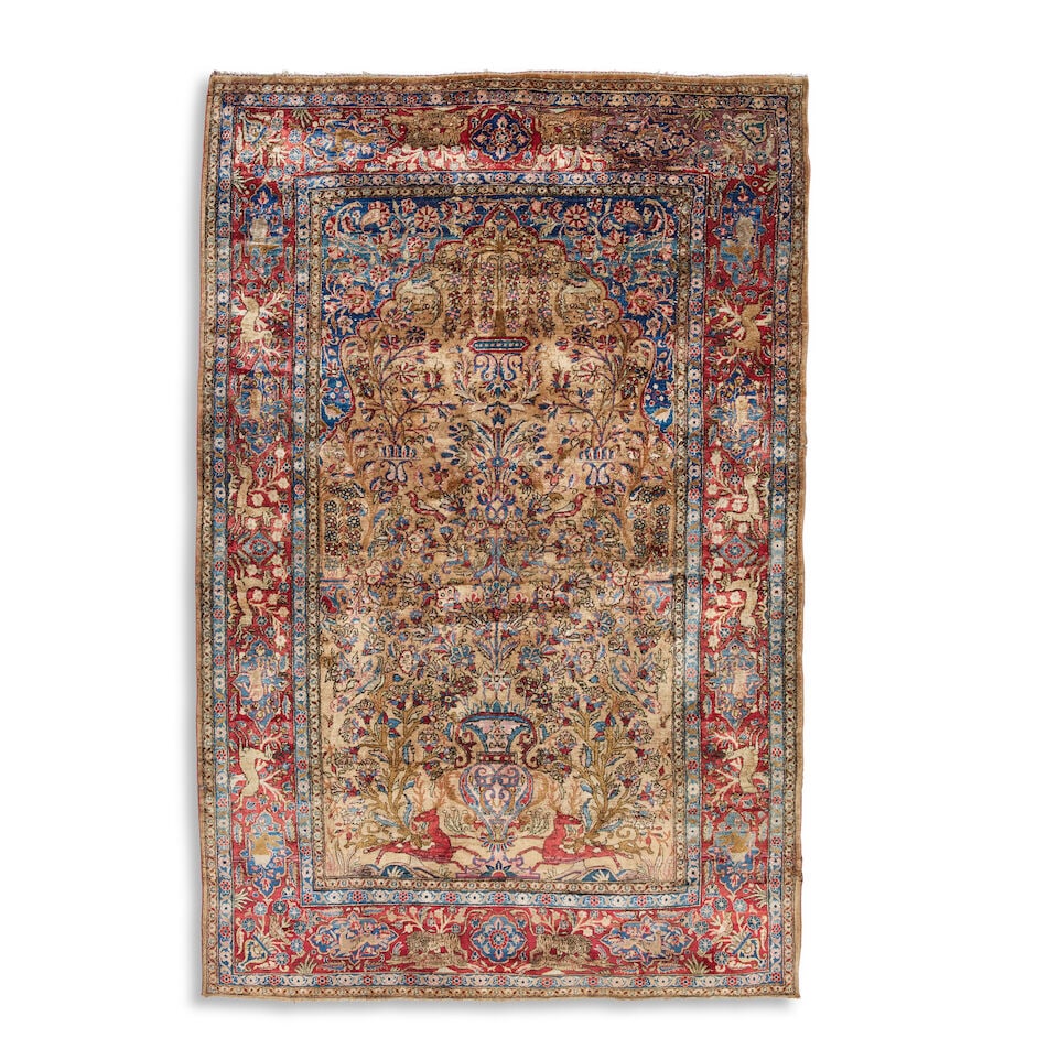 A Kashan silk prayer rug First quarter 20th century 204cm x 130.5cm: A Kashan silk prayer rug First quarter 20th century The central mihrab with tree-of-life, flowering vase and animals, the border with vignettes depicting animals including dogs, tigers, rabbits and de