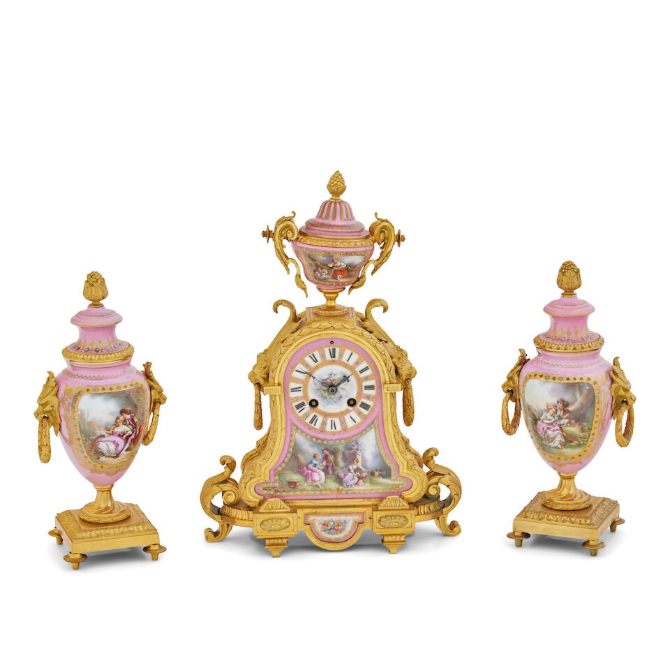 A 19th century Sevres style pink porcelain and ormolu clock garniture: A 19th century Sevres style pink porcelain and ormolu clock garniture The 3 1/2 inch dial with Roman numerals, the twin train movement striking a bell, stamped 'Japy Fres' contained within a case moun