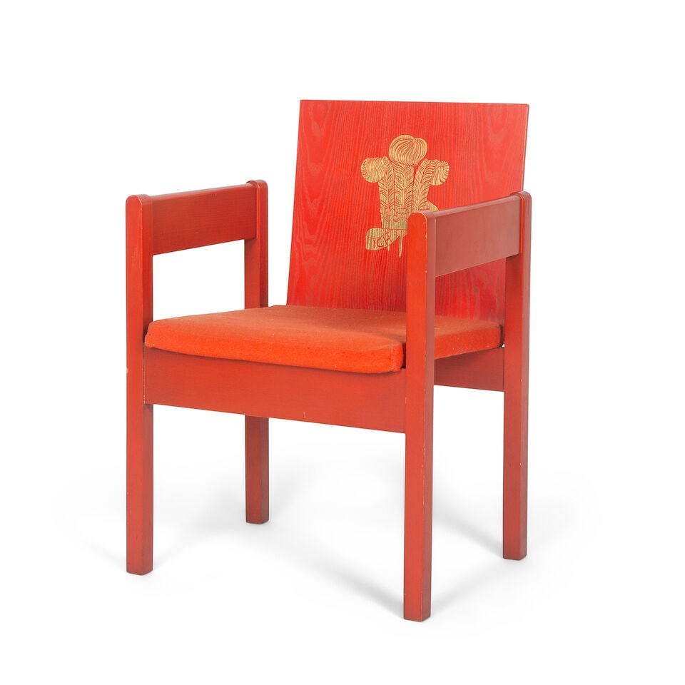 A 'Prince of Wales Investiture' chairDesigned by Lord Snowdon in 1969: A 'Prince of Wales Investiture' chair Designed by Lord Snowdon in 1969 Red painted all-over with Prince of Wales feathers carved to the back and highlighted in gilt, above a padded seat on square tape