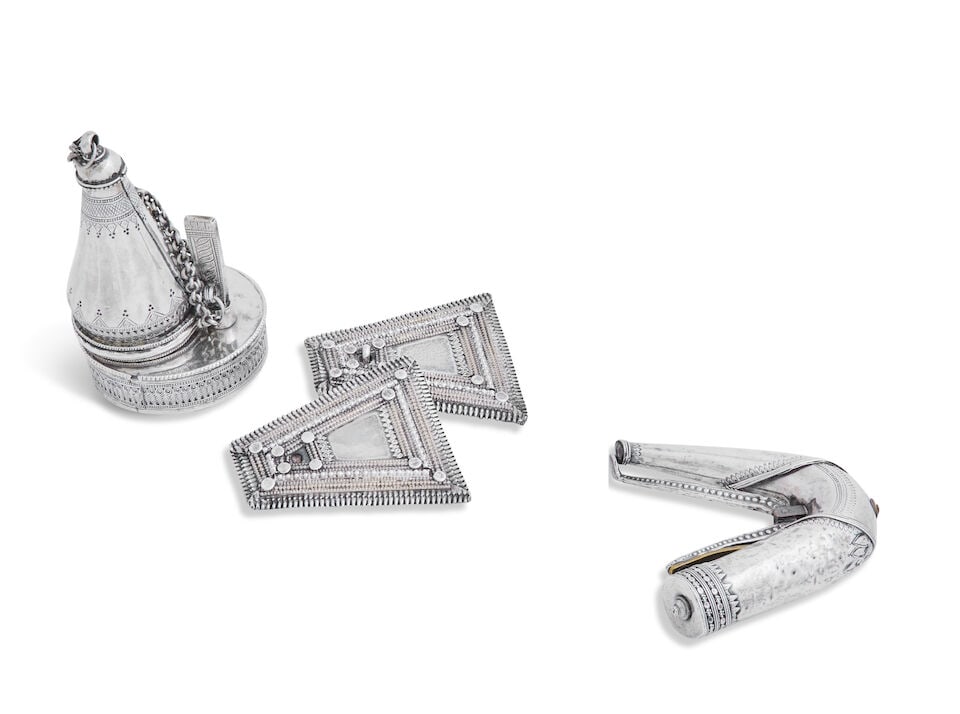 A middle eastern white metal and brass powder flask unmarked: A middle eastern white metal and brass powder flask unmarked Cast and engraved with banded decoration, 9.5cm long; together with a circular spice box, 11cm high and a pair of beaded triangular