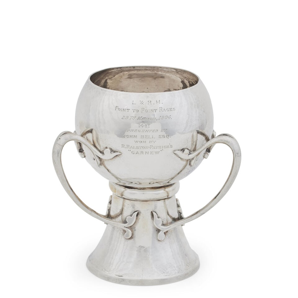 An Edwardian Irish silver tyg By James Wakely & Frank Clarke Wheeler Dublin, 1903: An Edwardian Irish silver tyg By James Wakely & Frank Clarke Wheeler Dublin, 1903 The high trumpet-shaped foot joined to the cup-shaped bowl by three bifurcated handles, engraved with a presentation i