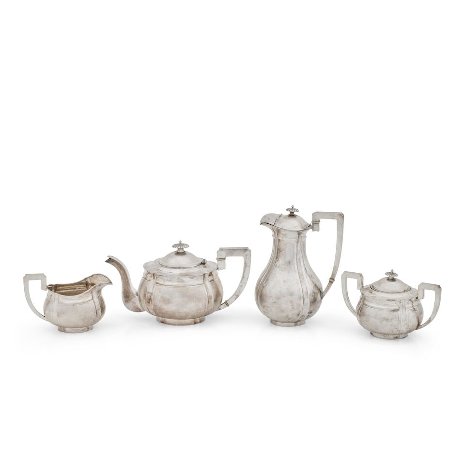 An early twentieth century four piece Chinese export silver tea service Maker's mark only for Ze...: An early twentieth century four piece Chinese export silver tea service Maker's mark only for Zee Wo, Shanghai, circa 1920 Each piece with oval panelled body and with matted ground, the teapot and hot