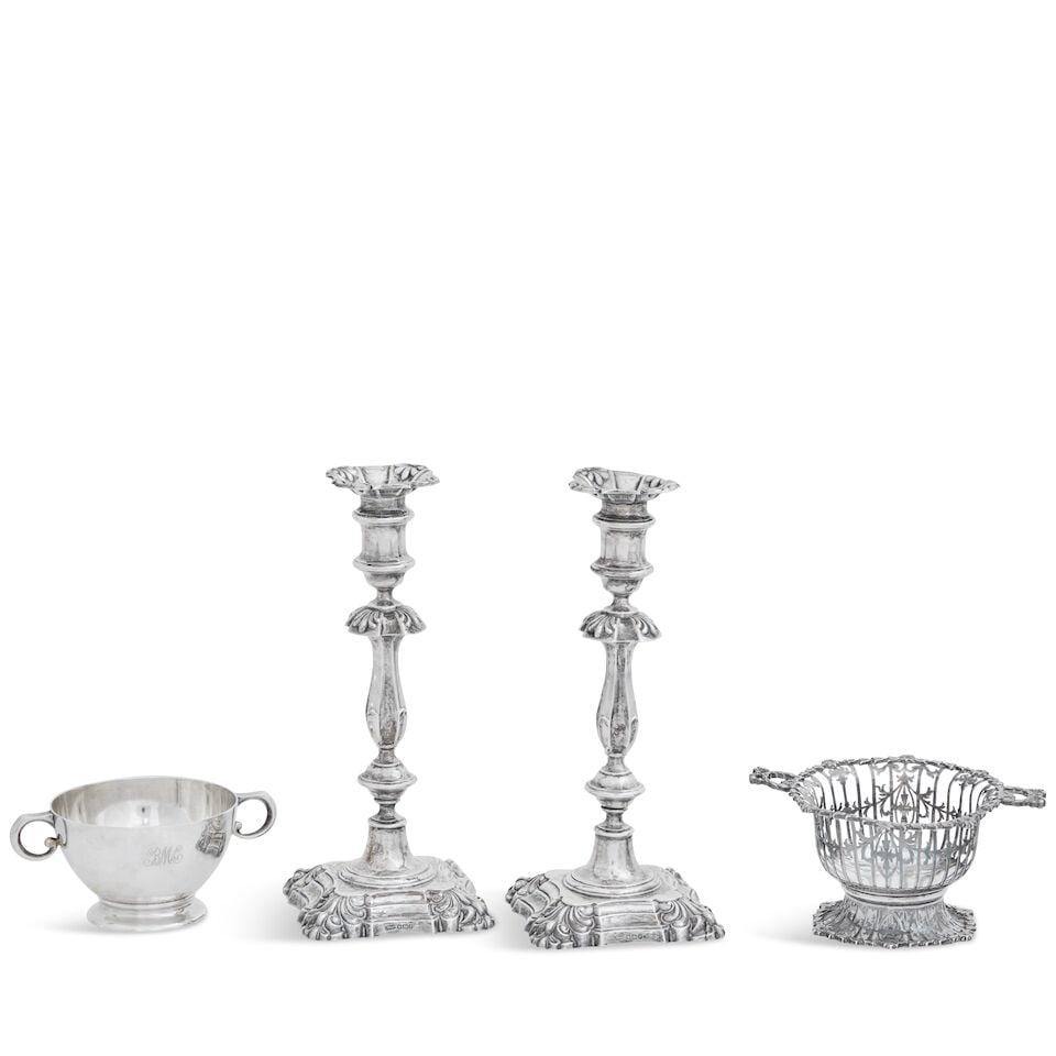 Pair of George II style silver candlesticks James Dixon & Sons, Sheffield 1932: Pair of George II style silver candlesticks James Dixon & Sons, Sheffield 1932 With anthemion cast drip pans and cusped slender baluster stems, on shaped square bases, loaded, 25cm high; together with