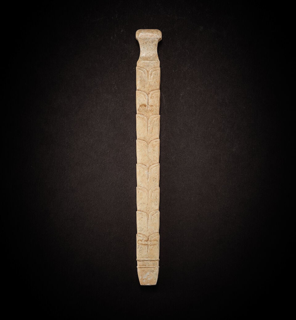 A JADE RIBBED ORNAMENT Shang Dynasty: A JADE RIBBED ORNAMENT Shang Dynasty 16cm long Footnotes: 商　玉柄形器 Provenance: Acquired in Hong Kong, 6 February