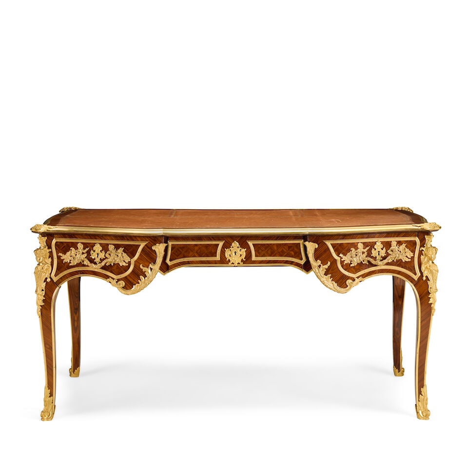 A large French kingwood, parquetry and gilt bronze mounted bureau platLate 19th century, in the ...: A large French kingwood, parquetry and gilt bronze mounted bureau plat Late 19th century, in the manner of Charles Cressent The shaped top inset with a gilt-tooled leather writing surface above three 