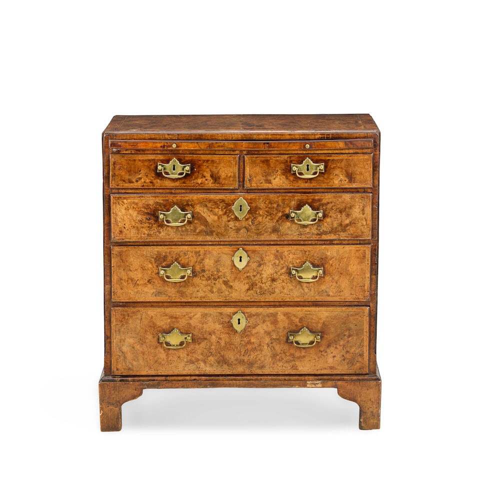 A fine George II walnut, crossbanded and featherbanded caddy top chestMid-18th century: A fine George II walnut, crossbanded and featherbanded caddy top chest Mid-18th century The quarter veneered top above a brushing slide, two short and three drawers on bracket feet, 71cm wide x 40cm