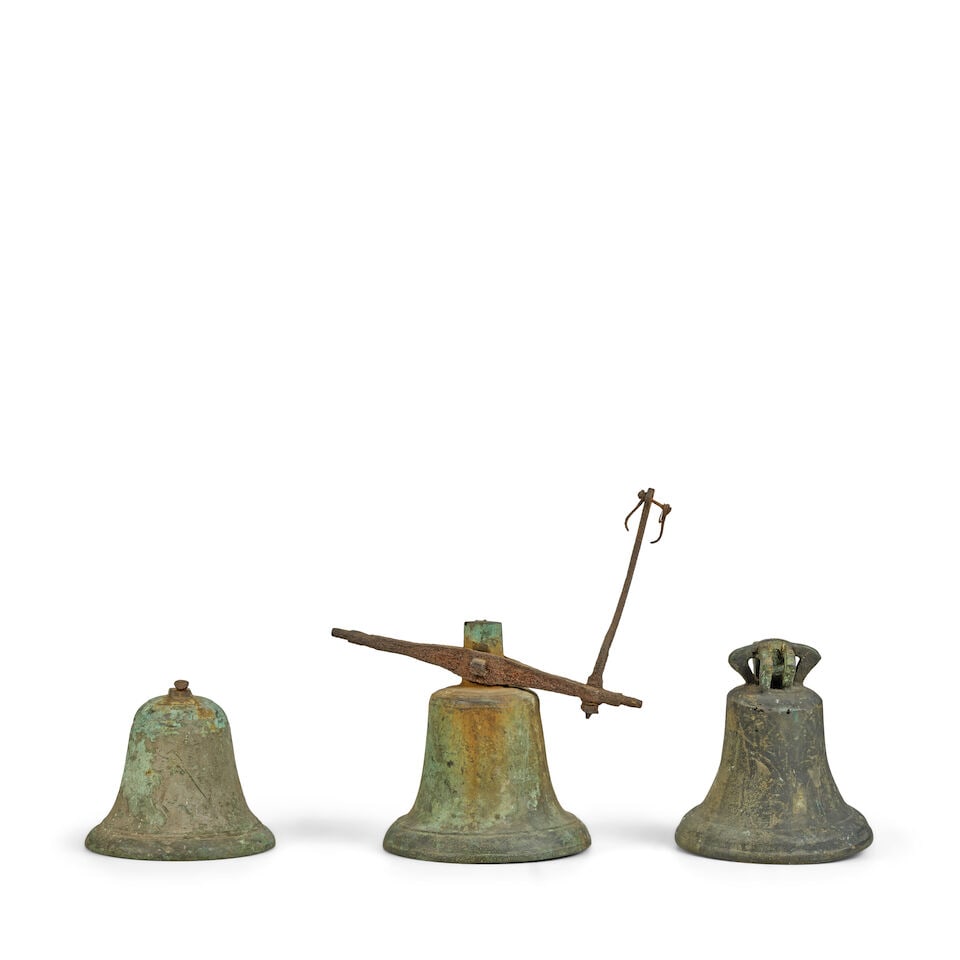 A collection of three bronze bells together with an early 20th century sundial The bells probab... (1 of 2)