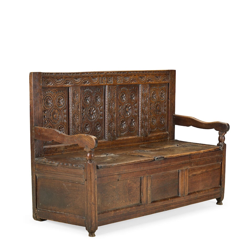An 18th century and later carved oak and elm box settle - 2