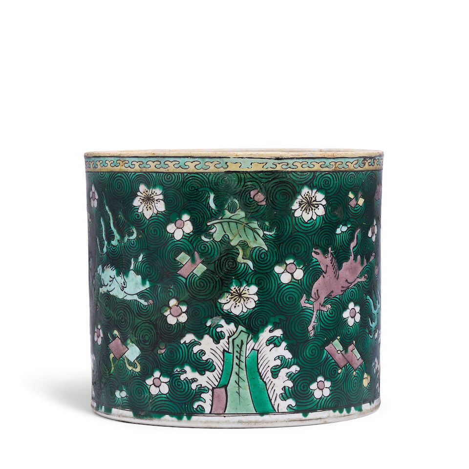 A famille verte Chinese brush pot, Bitong: A famille verte Chinese brush pot, Bitong Of typical cylindrical form, decorated with horses frolicking in a lush green landscape, 16cm high x 18.25cm diameter (6 1/4in high x 7 1/8in diameter) For