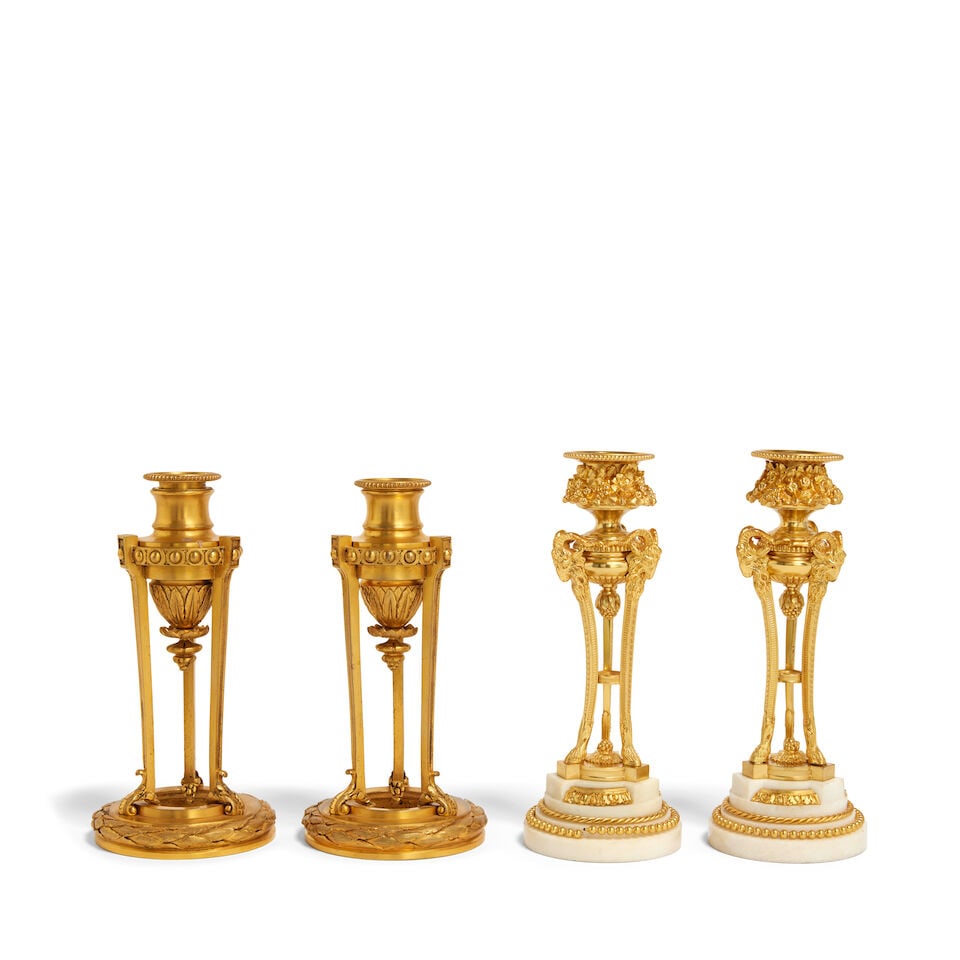 A pair of French marble and gilt bronze candle sticks, together with a pair of gilt bronze candl...: A pair of French marble and gilt bronze candle sticks, together with a pair of gilt bronze candle sticks French, late 19th / early 20th century in the Louis XVI style The first gilt pair with floral c