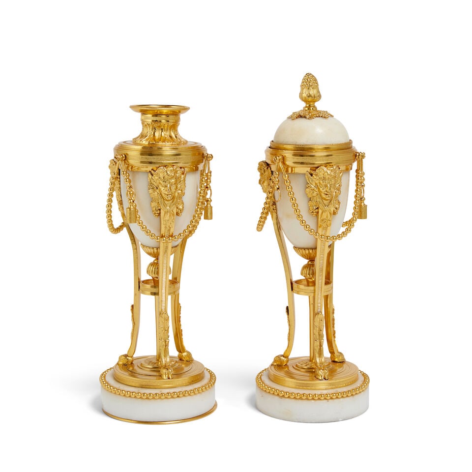 A pair of French marble and gilt bronze mounted cassolettes In the Louis XVI style (2): A pair of French marble and gilt bronze mounted cassolettes In the Louis XVI style The ovoid bodies on shaped and tapering milled tripod supports surmounted by fawn masks and terminating in cloven hoo