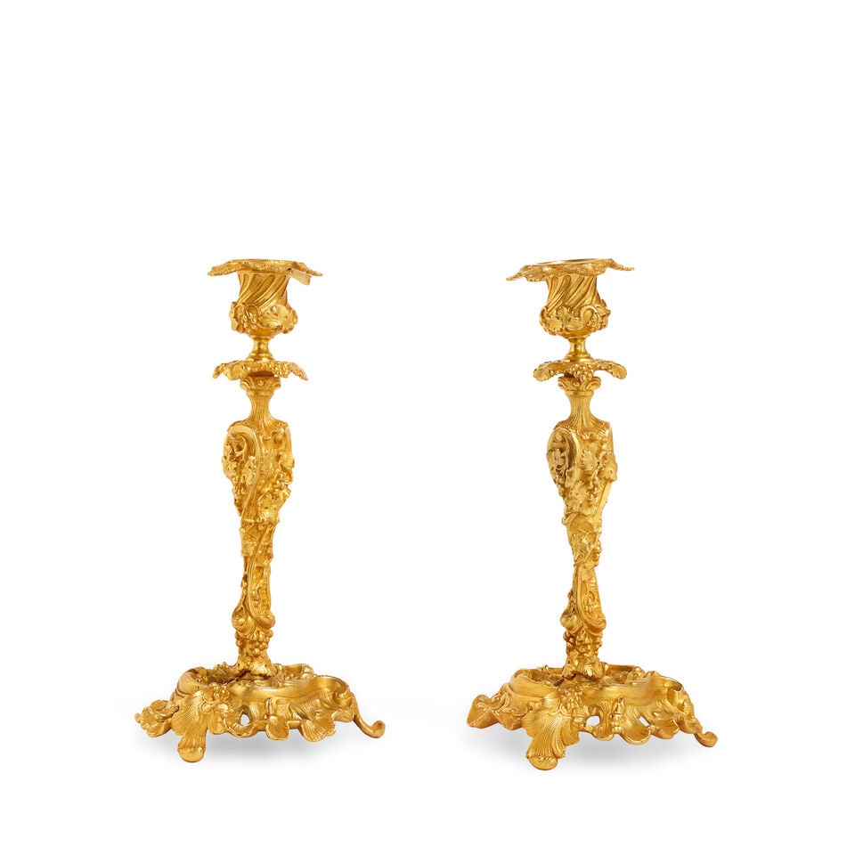 A pair of Louis XV style gilt bronze candlesticks In the Rococo style and in the manner of Juste...: A pair of Louis XV style gilt bronze candlesticks In the Rococo style and in the manner of Juste-Aurèle Meissonnier (1695-1750) The vine leaf cast drip-pans above a profusely cast stem decorated 