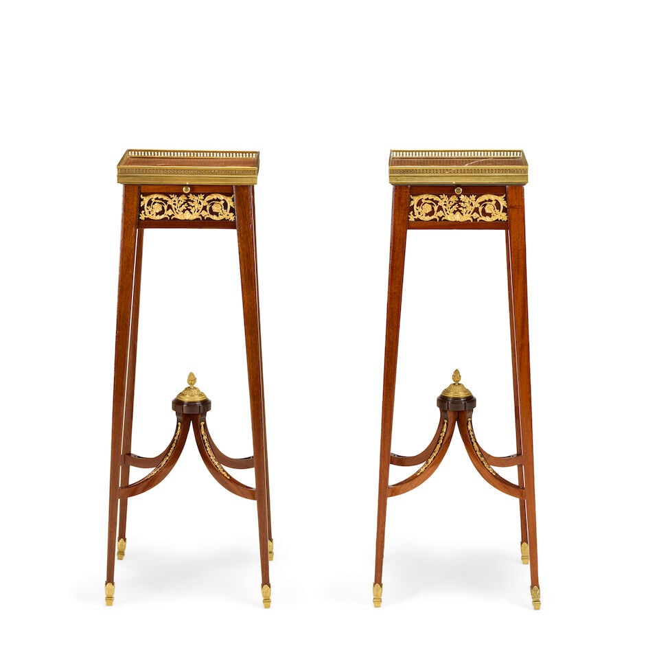 A near pair of French mahogany and gilt bronze mounted urn stands or selettesLate 19th / early 2...: A near pair of French mahogany and gilt bronze mounted urn stands or selettes Late 19th / early 20th century and later in the Louis XVI style, in the manner of François Linke (1855-1946) The marb