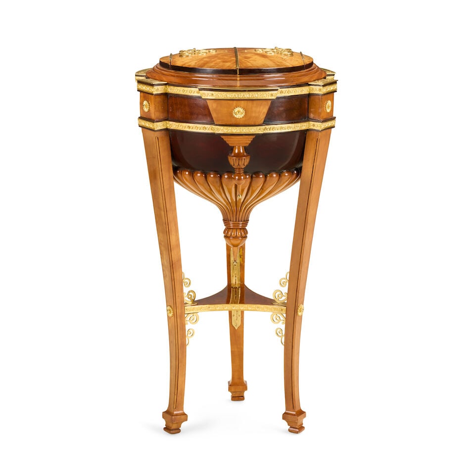 A Northern European satinwood and gilt brass mounted worktableMid-19th century and later: A Northern European satinwood and gilt brass mounted worktable Mid-19th century and later The hinged domed and divided top with gilt-brass entwined cypher handles enclosing a silk lined interior and