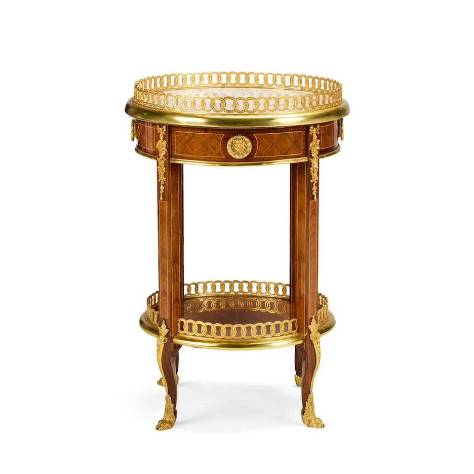 A French tulipwood, parquetry and gilt bronze mounted table en chiffonnièreLate 19th centur...: A French tulipwood, parquetry and gilt bronze mounted table en chiffonnière Late 19th century and later in the Louis XVI style and in the manner of Martin Carlin (1730-1785) The circular marble t