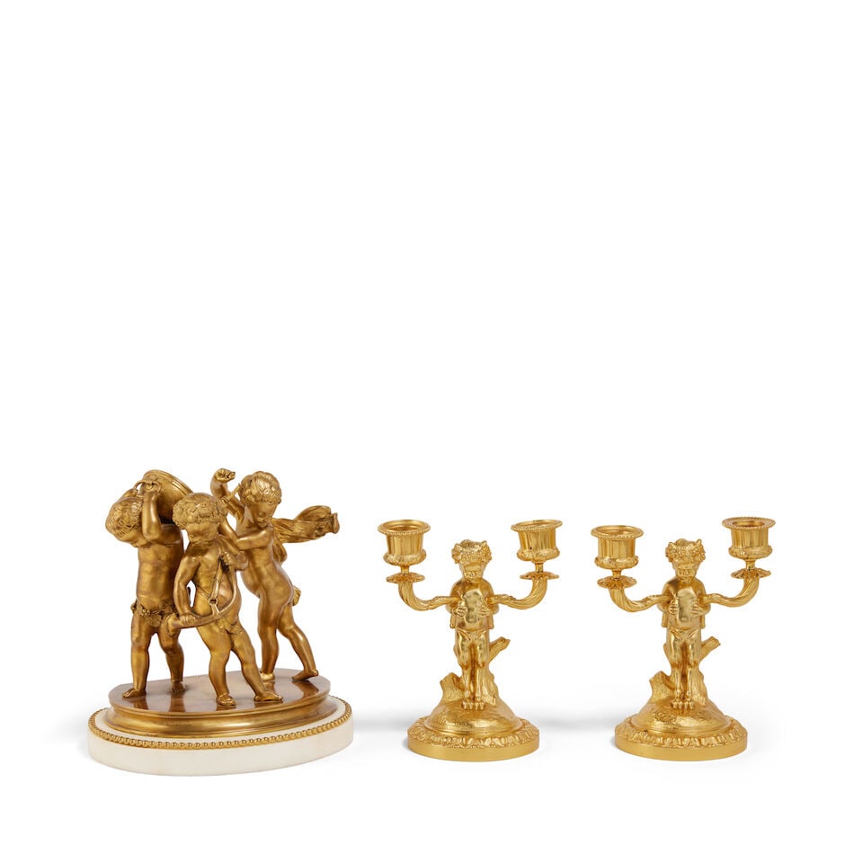 After Claude Michel Clodion (French, 1738 - 1814): a gilt bronze figural group of three musical ...: After Claude Michel Clodion (French, 1738 - 1814): a gilt bronze figural group of three musical putti French, late 19th century The three figures banging a drum and holding a horn on a moulded base si