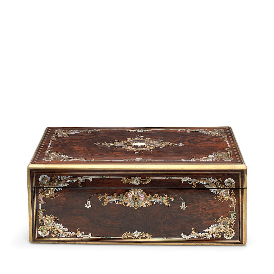A rosewood, cut brass, engraved mother of pearl inlaid and brass bound writing slope Second qua...: A rosewood, cut brass, engraved mother of pearl inlaid and brass bound writing slope Second quarter 19th century The case profusely inlaid with foliate scrolls and flower heads, the hinged lid enclosi