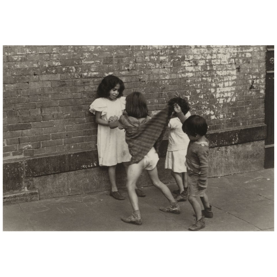 Helen Levitt (1913-2009); New York (Boy Lifting Skirt);: Helen Levitt (1913-2009) New York (Boy Lifting Skirt), c. 1942 Gelatin silver print, printed later; signed, dated 'ca. 1942', and annotated 'n.y.' in pencil on the reverse, framed, a Fraenkel Gallery 