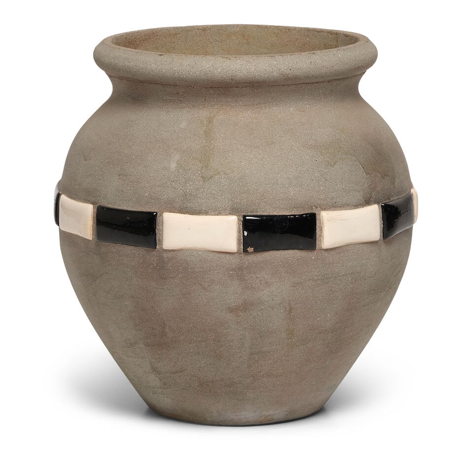 A CALIFORNIA HILLSIDE POTTERY BLACK AND WHITE TILE INSET CEMENT VASELos Angeles, 20th century: A CALIFORNIA HILLSIDE POTTERY BLACK AND WHITE TILE INSET CEMENT VASE Los Angeles, 20th century height 19 1/2in; diameter 14 3/4in Footnotes: From Diane Keaton's living room in her Sullivan Canyon
