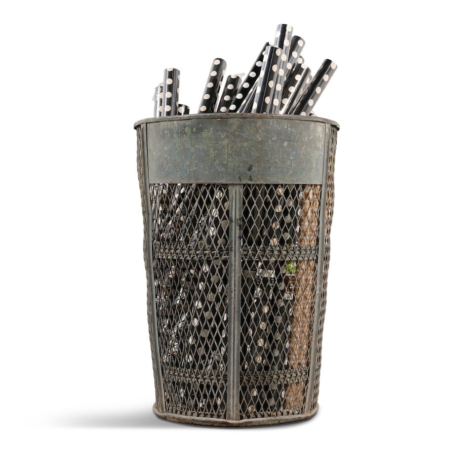 A LARGE INDUSTRIAL PIERCED METAL BASKET FILLED WITH BLACK AND WHITE WRAPPING PAPER - 3