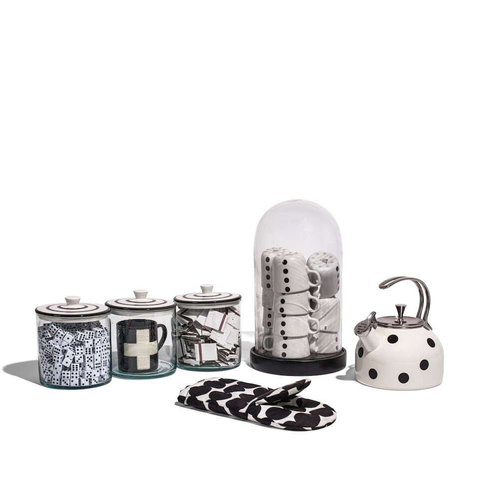 A CURATED SELECTION OF BLACK AND WHITE KITCHEN DECORATIONS: A CURATED SELECTION OF BLACK AND WHITE KITCHEN DECORATIONS Comprising a glass dome filled with coffee cups, three glass jars filled with matches, dice, and a coffee mug, a kettle, and an oven mitt. (6