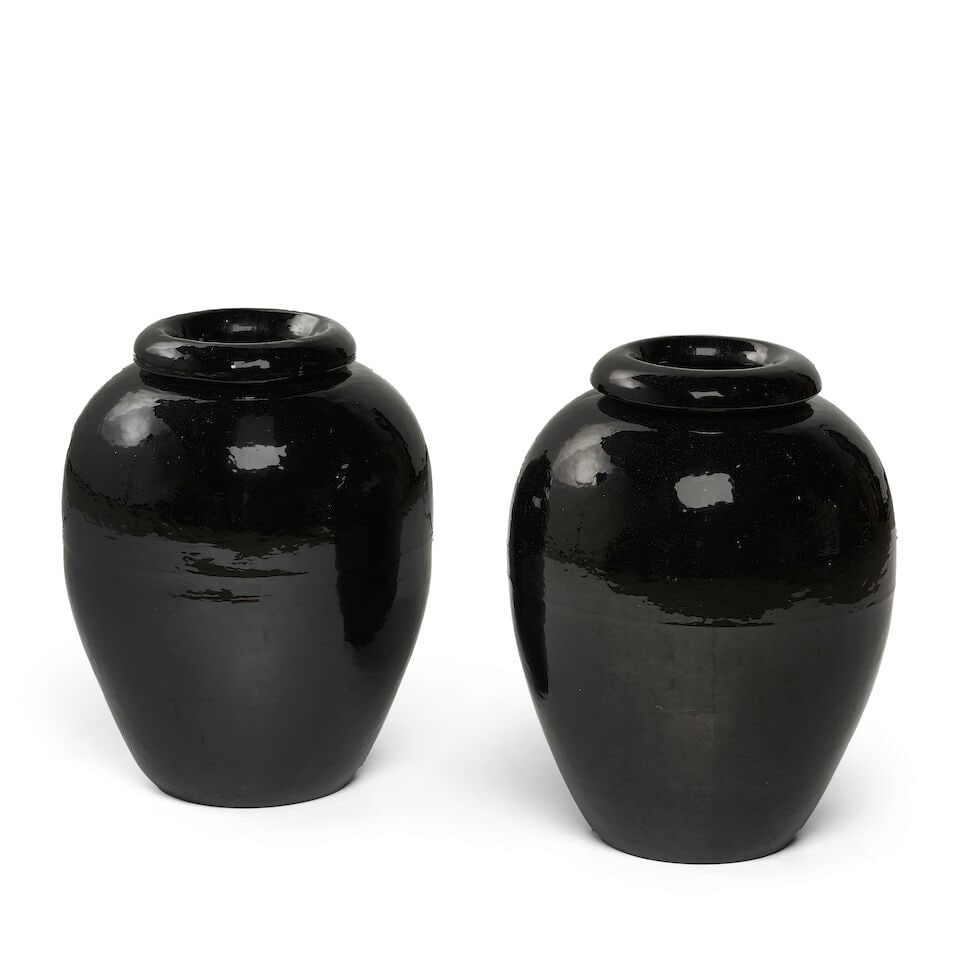 A PAIR OF BLACK GLAZED VASES: A PAIR OF BLACK GLAZED VASES height 21 1/2in; diameter 9 1/2in Footnotes: From Diane Keaton's Sullivan Canyon home. This lot is subject to the following lot symbols: ¤ ¤ Unless indicated by