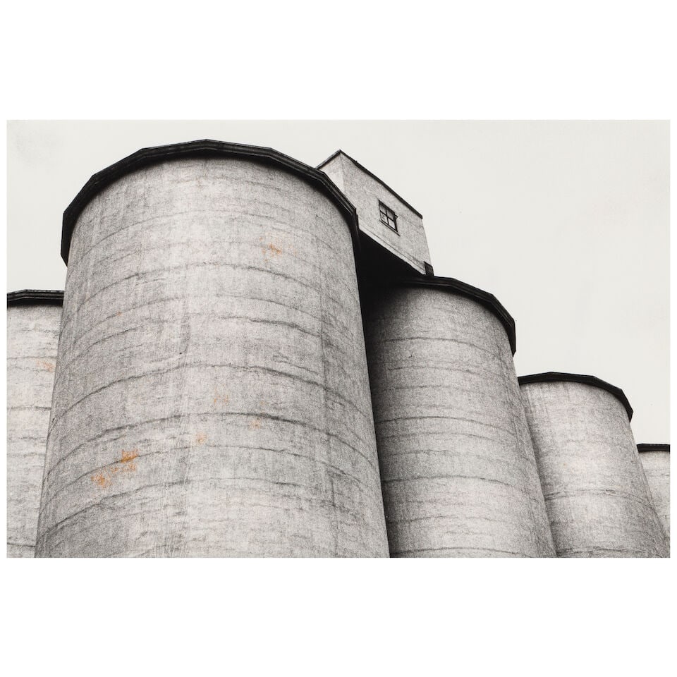 ANONYMOUS: A BLACK AND WHITE PHOTOGRAPH: UNTITLED (HOUSE ON SILOS)1979 (1 of 3)