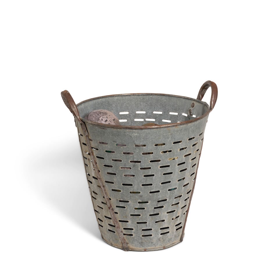 AN INDUSTRIAL PIERCED METAL TWO-HANDLED BASKET FILLED WITH ORBS - 2