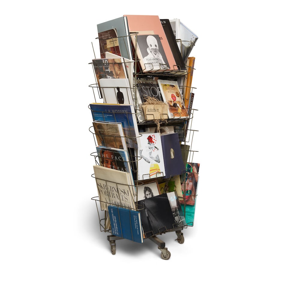 AN INDUSTRIAL METAL RACK CURATED WITH BOOKS, MAGAZINES, AND OBJECTS - 3