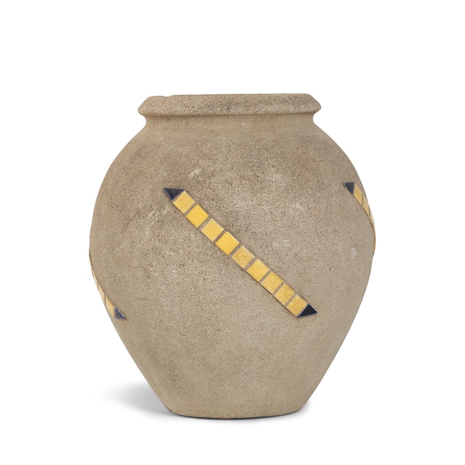 A CALIFORNIA HILLSIDE POTTERY SQUARE TILE INSET ARROW CEMENT VASELos Angeles, 20th century: A CALIFORNIA HILLSIDE POTTERY SQUARE TILE INSET ARROW CEMENT VASE Los Angeles, 20th century height 14 1/4in; diameter 13 1/2in Footnotes: From Diane Keaton's library in her Beverly Hills