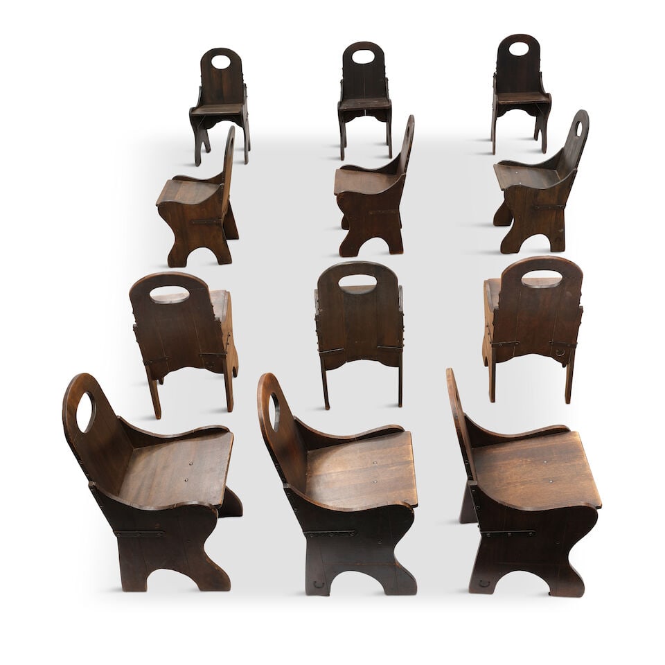 A SET OF TWELVE MONTEREY IRON AND OLD WOOD LIGHT STAINED WOOD 'MONK'S' CHAIRSCirca 1930: A SET OF TWELVE MONTEREY IRON AND OLD WOOD LIGHT STAINED WOOD 'MONK'S' CHAIRS Circa 1930 With branded horseshoe insignia, some also branded MONTEREY. height 34in; width 17 1/4in; depth 18in Footnotes: