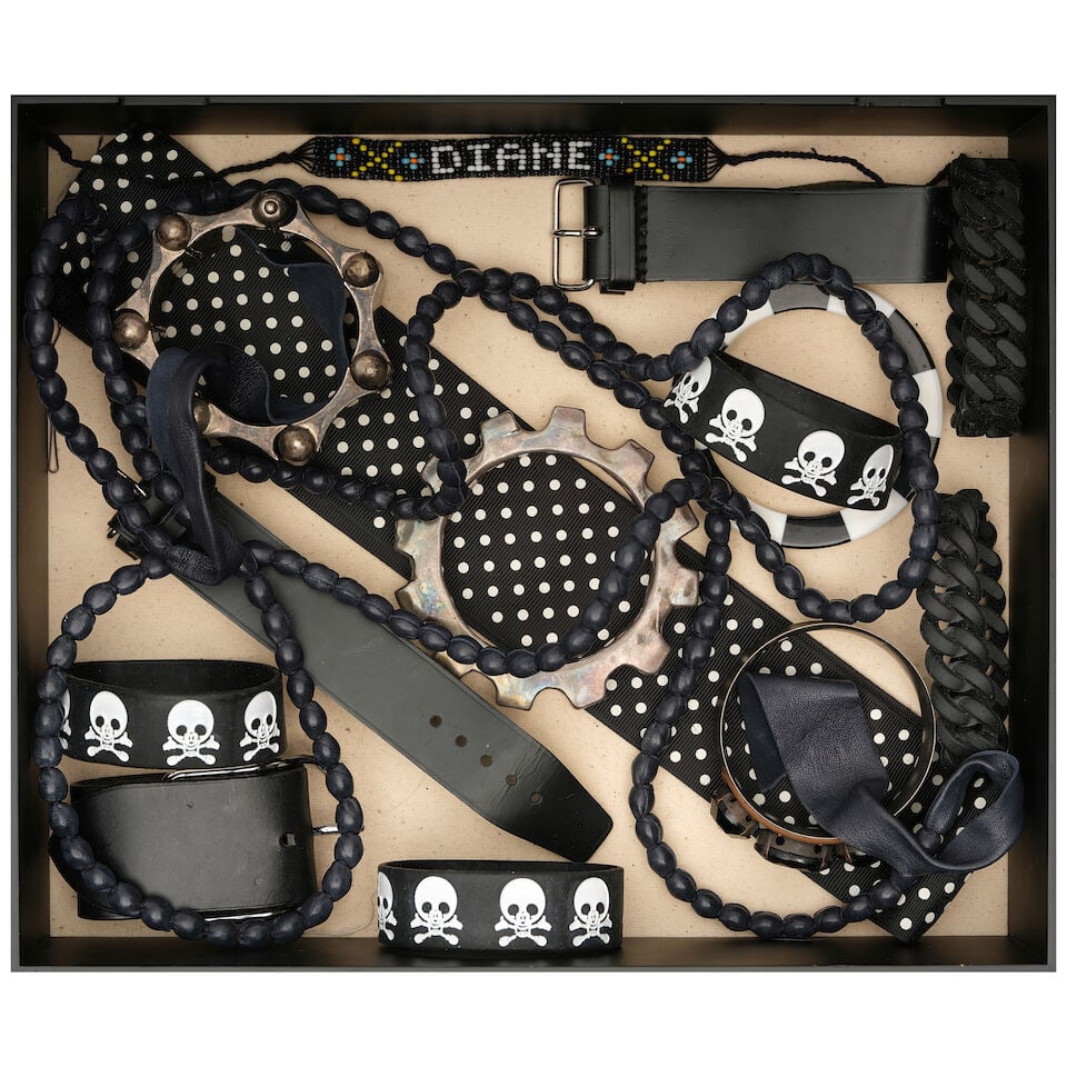 A CURATED BOX OF PUNK INSPIRED JEWELRY AND ACCESSORIES: A CURATED BOX OF PUNK INSPIRED JEWELRY AND ACCESSORIES Including three rubber skull bracelets, a beaded bracelet spelling DIANE, two Louis Vuitton leather cuffs, a Hermes leather cuff, and a thick