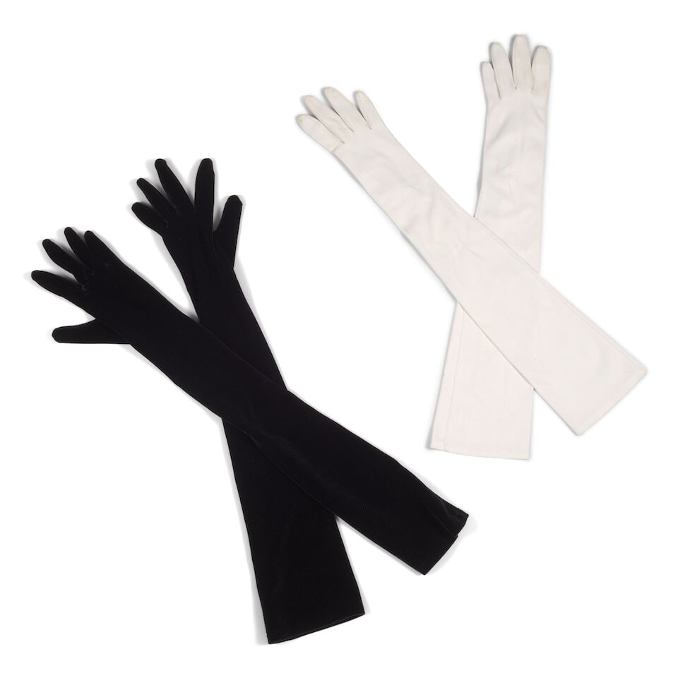 TWO PAIRS OF GLOVES: TWO PAIRS OF GLOVES Comprising a pair of white gloves with faux pearl buttons and a pair of La Crasia black gloves. lengths 21 3/4in to 25in This lot is subject to the following lot symbols: