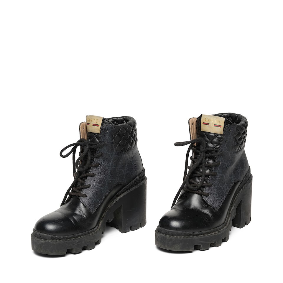 A PAIR OF GUCCI BLACK GG COMBAT BOOTS: A PAIR OF GUCCI BLACK GG COMBAT BOOTS Marked size 40. This lot is subject to the following lot symbols: ¤ ¤ Unless indicated by the ¤ symbol next to the lot number (or bearing an