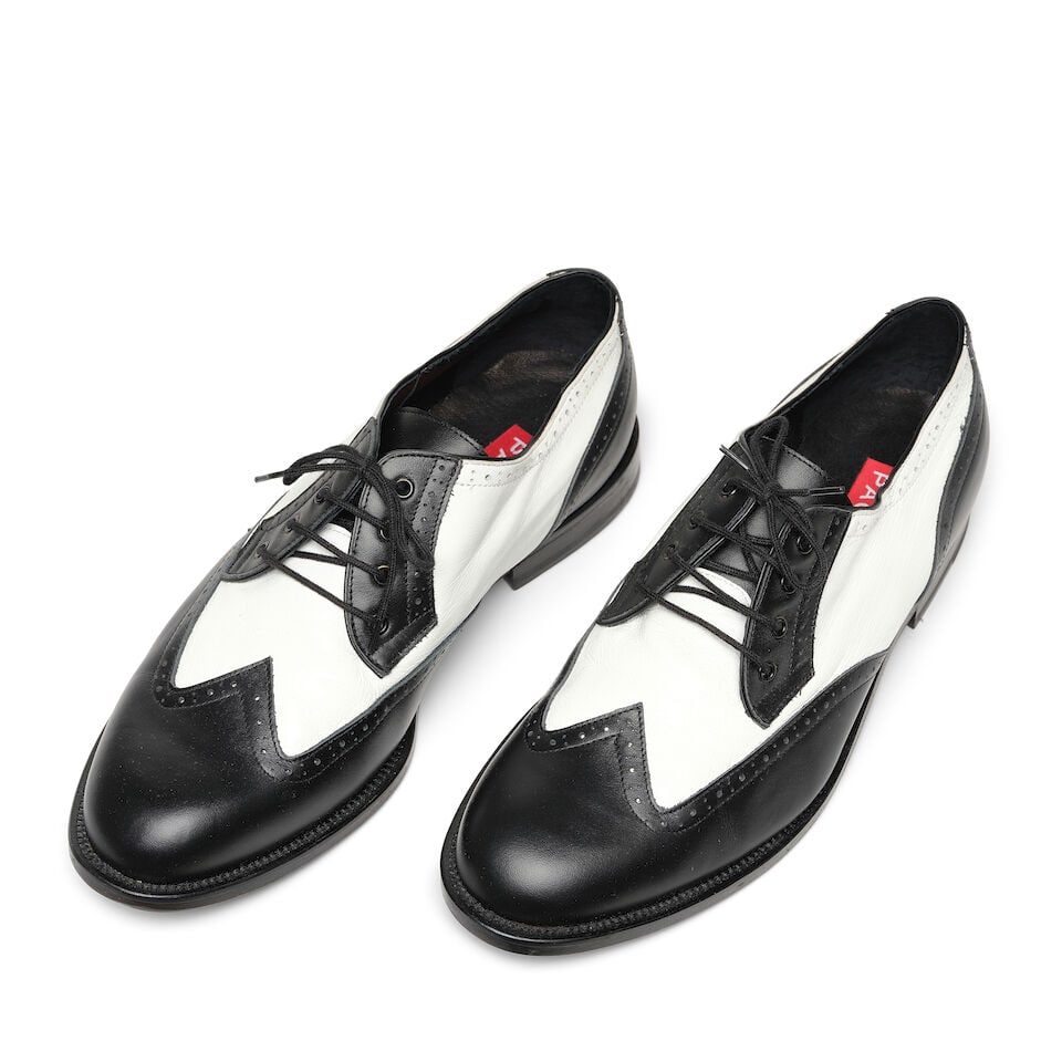 A PAIR OF PAOUL BLACK AND WHITE WING TIP LACE UP DANCING SHOES: A PAIR OF PAOUL BLACK AND WHITE WING TIP LACE UP DANCING SHOES Marked size 42. This lot is subject to the following lot symbols: ¤ ¤ Unless indicated by the ¤ symbol next to the lot num