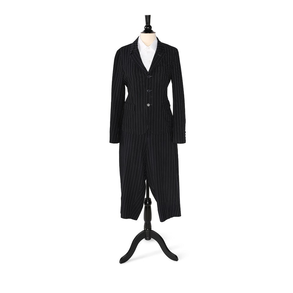 A COMME DE GARÇON NAVY AND WHITE PINSTRIPE SUIT: A COMME DE GARÇON NAVY AND WHITE PINSTRIPE SUIT Comprising a pair of Comme de Garçon cropped pants and jacket set, the jacket marked size S, the pants unmarked, and a Turnball & Asher white 