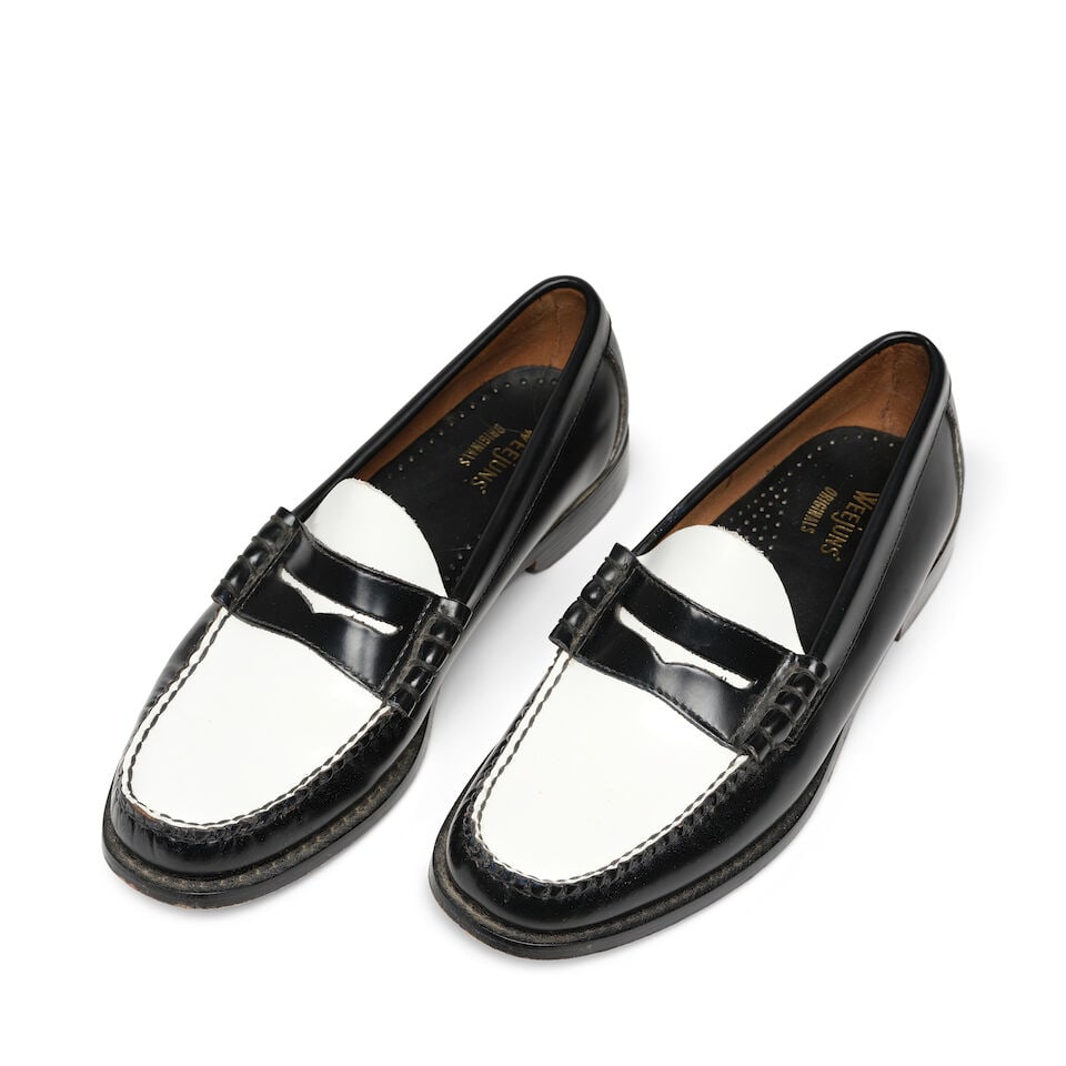 A PAIR OF G.H. BASS LARSON WEEJUNS BLACK AND WHITE LOAFERS: A PAIR OF G.H. BASS LARSON WEEJUNS BLACK AND WHITE LOAFERS No marked size. length 11 1/4in This lot is subject to the following lot symbols: ¤ ¤ Unless indicated by the ¤ symbol next
