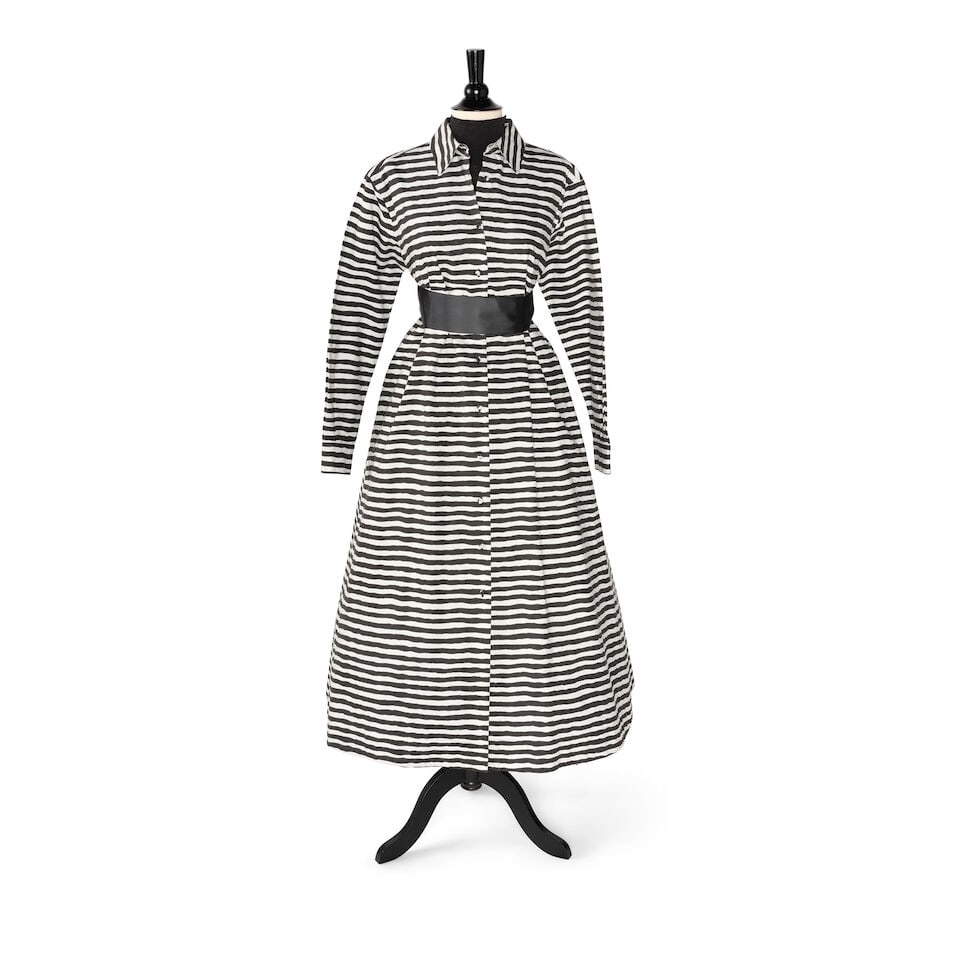 A BLACK AND WHITE STRIPED DRESS: A BLACK AND WHITE STRIPED DRESS Unmarked, together with a black petticoat and a black turtleneck. (3) shoulders approximately 17in; length 52in Please note, this look was styled with a black ribbon