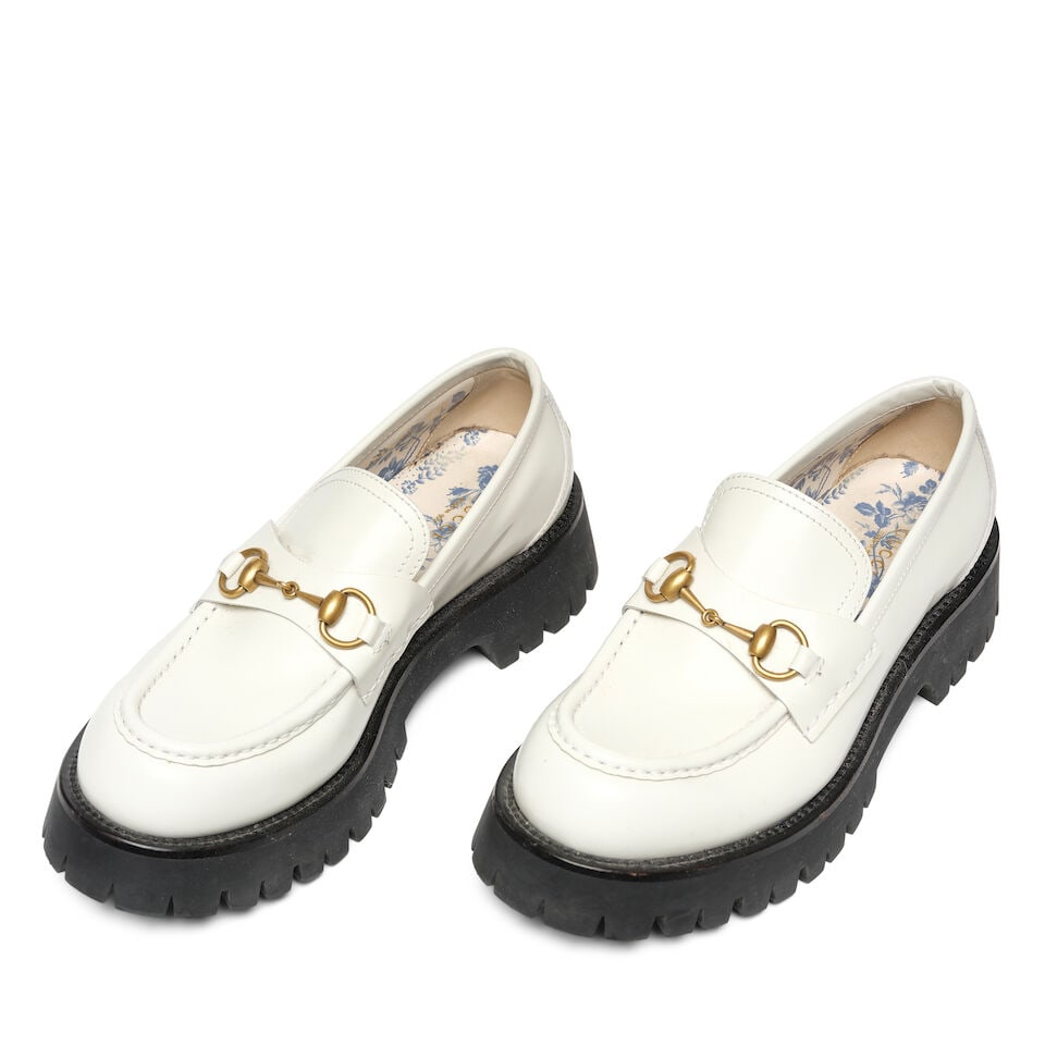 A PAIR OF GUCCI WHITE LEATHER HARALD HORSEBIT PLATFORM LOAFERS: A PAIR OF GUCCI WHITE LEATHER HARALD HORSEBIT PLATFORM LOAFERS Marked size 41. Footnotes: Literature Keaton, Diane. Fashion First. Rizzoli, New York, 2024. This lot is subject to the following lot sym
