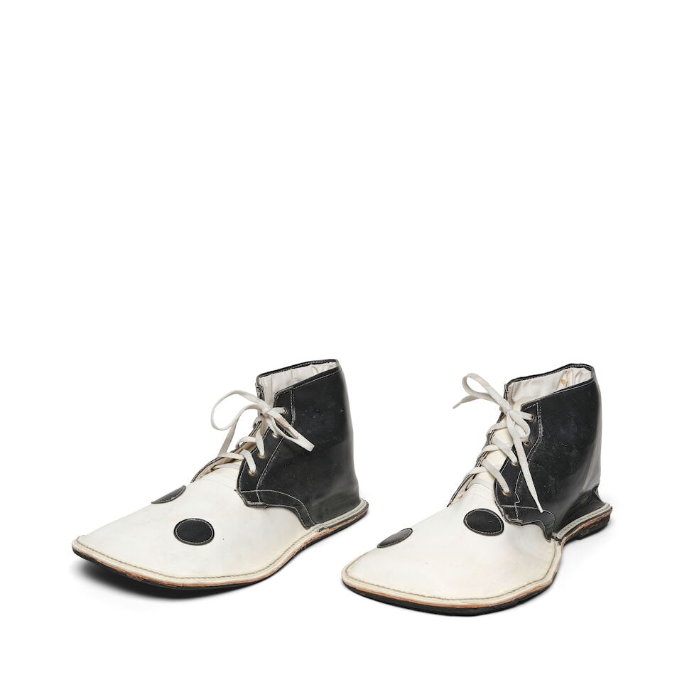A PAIR OF BLACK AND WHITE CLOWN SHOES: A PAIR OF BLACK AND WHITE CLOWN SHOES No marked size. length 13 3/4in Footnotes: Gifted from Ray Azoulay, owner of Obsolete, Los Angeles. This lot is subject to the following lot symbols: