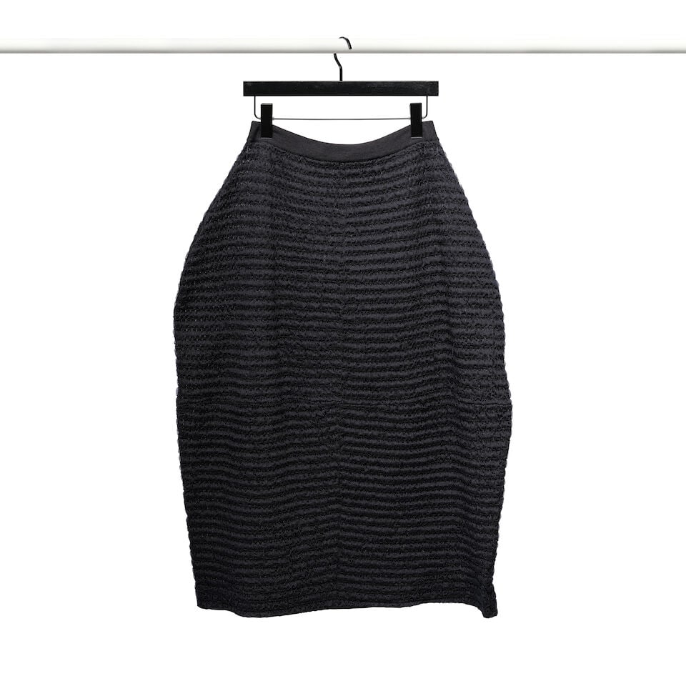 A JIL SANDER NAVY BLUE TEXTURED SKIRT: A JIL SANDER NAVY BLUE TEXTURED SKIRT No marked size; together with a black petticoat. waist approximately 27in Footnotes: Worn on The Ellen DeGeneres Show in February 2019 and featured on