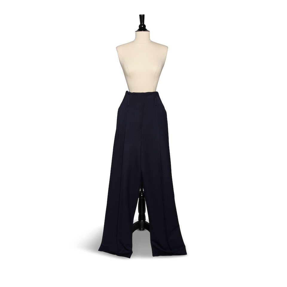 A PAIR OF CÉLINE NAVY PLEATED PANTS: A PAIR OF CÉLINE NAVY PLEATED PANTS No marked size. waist 31 1/2in This lot is subject to the following lot symbols: ¤ ¤ Unless indicated by the ¤ symbol next to the lot number
