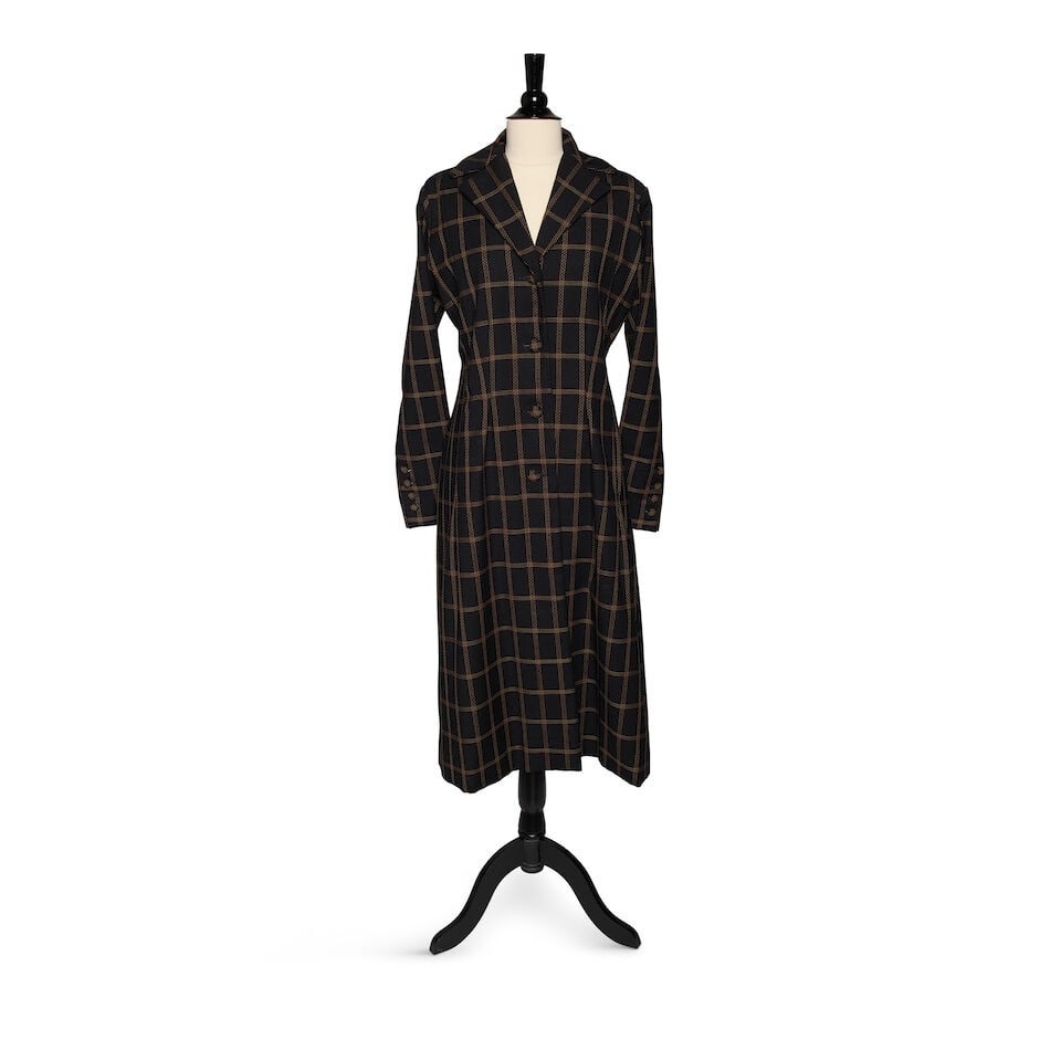 A BLACK, ORANGE, AND WHITE PLAID COAT: A BLACK, ORANGE, AND WHITE PLAID COAT No marked size. shoulders 17 1/2in, length 47in This lot is subject to the following lot symbols: ¤ ¤ Unless indicated by the ¤ symbol next to the