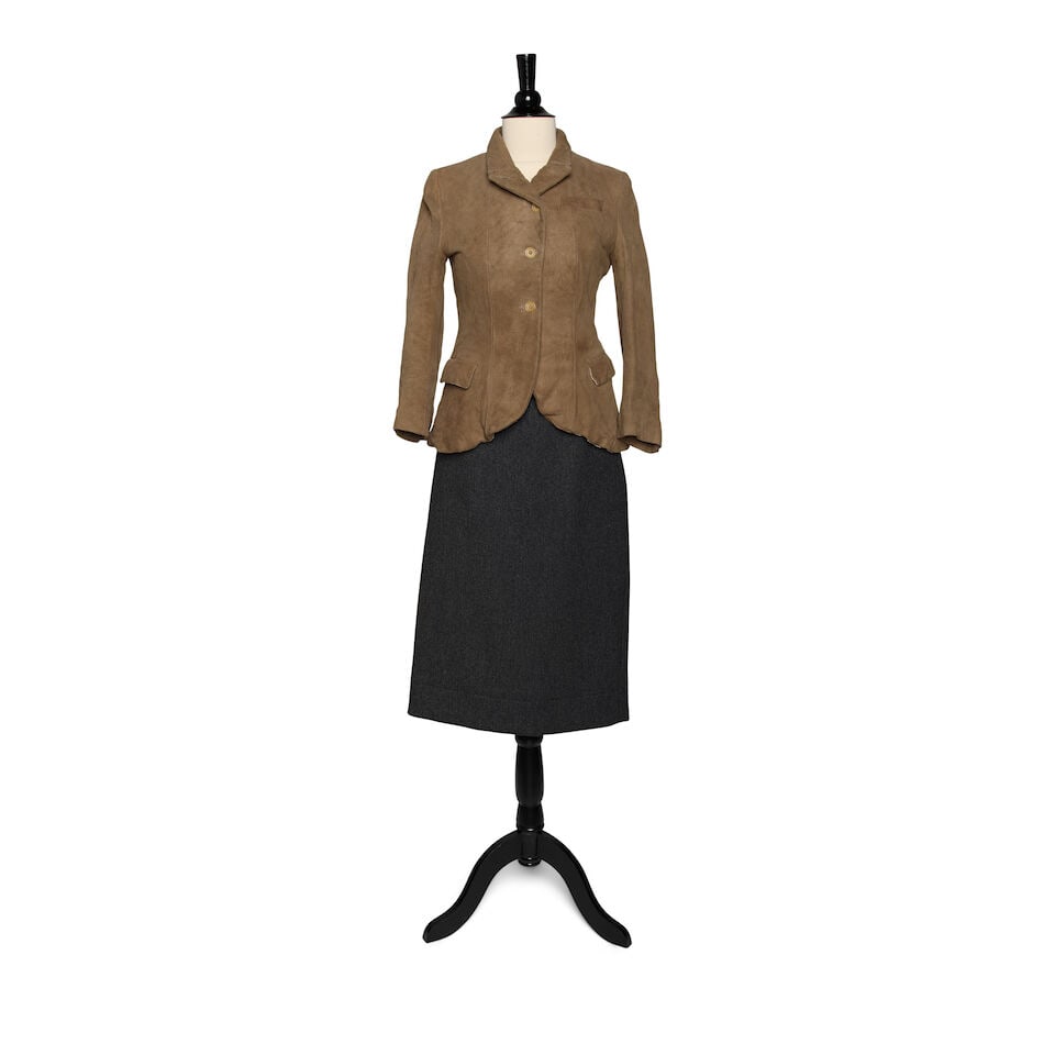 A PAUL HARNDEN SHOEMAKERS TAN SUEDE BLAZER AND A PRADA GRAY PENCIL SKIRT: A PAUL HARNDEN SHOEMAKERS TAN SUEDE BLAZER AND A PRADA GRAY PENCIL SKIRT The blazer marked size S, the Prada skirt marked size 42. This lot is subject to the following lot symbols: ¤ ¤ Unles