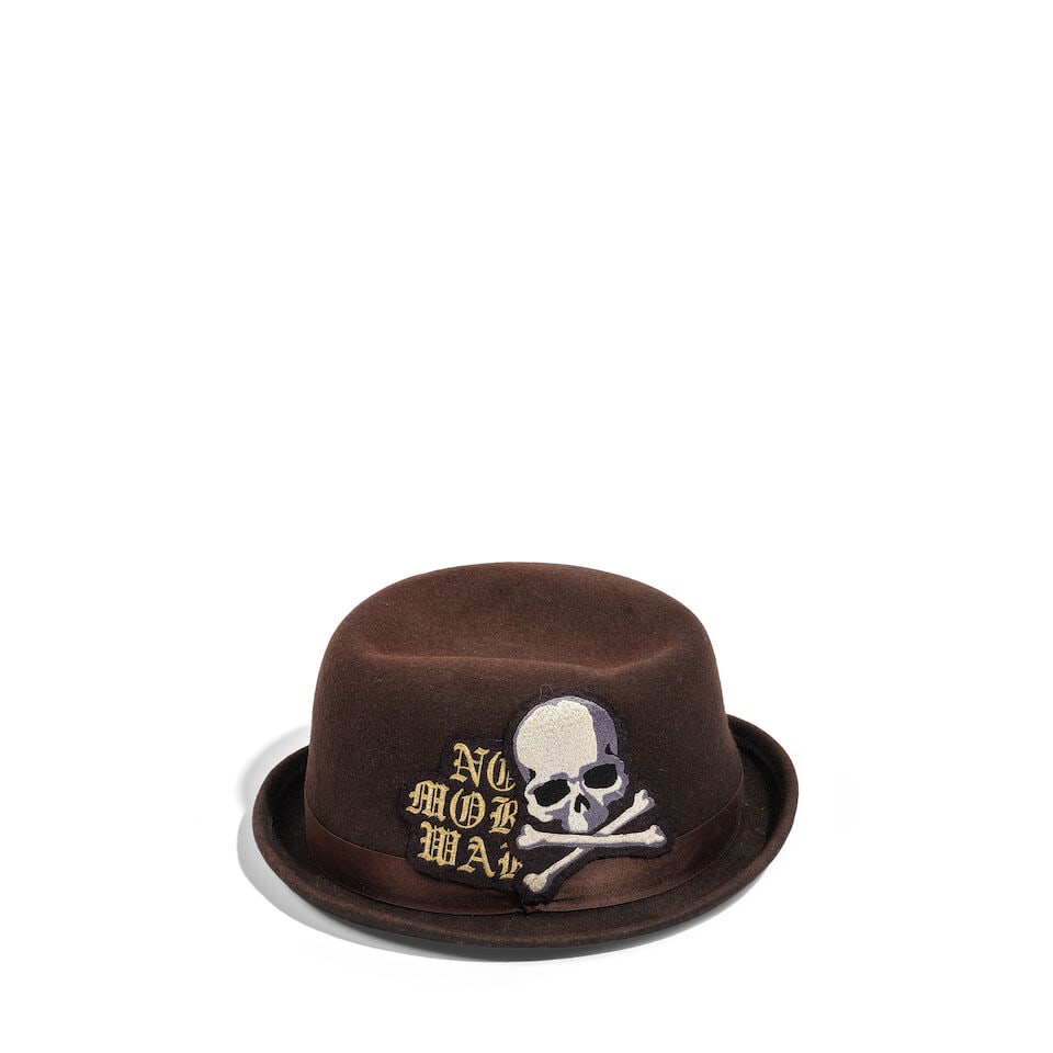 A MASTERMIND JAPAN BROWN WOOL 'NO MORE WAR' BOWLER HAT WITH RIBBON: A MASTERMIND JAPAN BROWN WOOL 'NO MORE WAR' BOWLER HAT WITH RIBBON Marked size L. Footnotes: Worn on multiple occasions, including The Tonight Show with Jay Leno 26 April 2012. This lot is subject to 